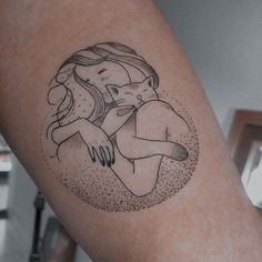 a woman with a cat tattoo on her arm