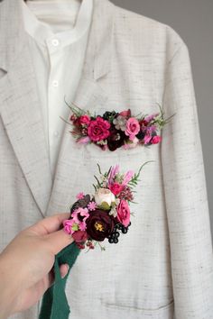 a person in a suit with flowers on his lapel