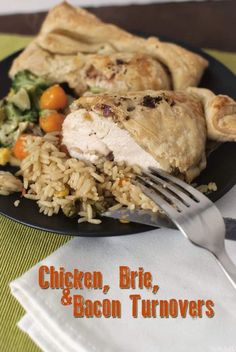 chicken, brie, and bacon turnovers on a black plate with a fork