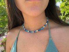 Dainty Surfer summer choker, beaded choker necklace, blue choker for women, surfer jewerly gift for women Dainty Surfer choker necklace style in blue color, with gold plated brass beads, white shell beads and polymer clay beads. In this list the choker is in blue color but is avalaible in other colors at my store. The diammeter of the beads is 4mm and the lenght of the choker is 35cms + 5 cms of extra chain. These simple, delicate and versatil choker that you can wear at any occassion. Confortab Blue Tiny Beads Choker For Summer, Trendy Blue Choker With Tiny Beads, Summer Turquoise Choker With Colorful Beads, Handmade Blue Jewelry For Beach Season, Trendy Blue Beaded Choker, Trendy Blue Choker With Colorful Beads, Casual Blue Beaded Choker, Blue Tiny Beads Jewelry For Beach Season, Blue Beachy Necklace