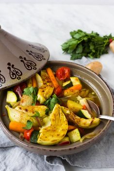 a bowl filled with vegetables on top of a table