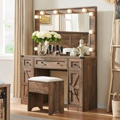 a wooden vanity with lights on it and a stool in front of the mirror that is open