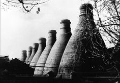 black and white photograph of large stacks of cement