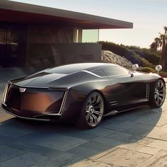 a futuristic car parked in front of a house