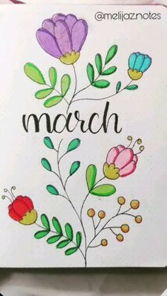 an open notebook with flowers and the word march written in cursive writing on it