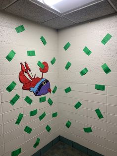 a bathroom with green sticky notes on the wall and a cartoon character painted on the wall