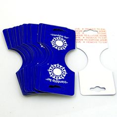 six blue luggage tags are shown on a white surface