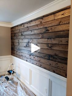 a room that has been painted with wood planks and white paint on the walls