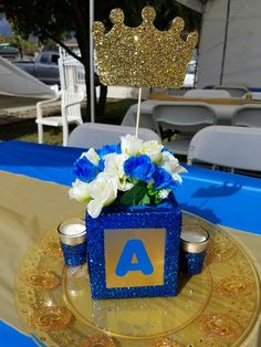 a blue and gold centerpiece on a table