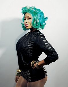 a woman with green hair is posing for the camera while holding her hands on her hips