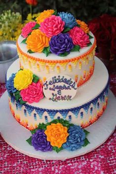 there is a three layer cake decorated with flowers