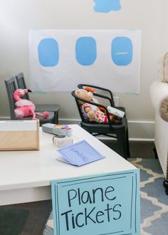 there is a plane ticket on the table in this living room with two children's chairs