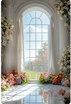 an arched window is filled with flowers and greenery in front of a white marble table