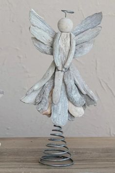 a white angel figurine sitting on top of a wooden table