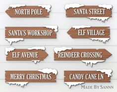 wooden signs that say santa's workshop, elf village, reindeer crossing and candy cane inn