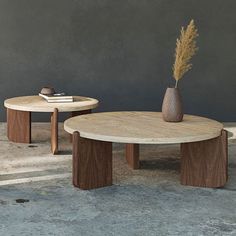 two wooden tables sitting next to each other on top of cement floored area with concrete walls behind them