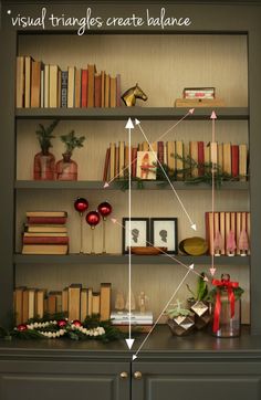 a bookshelf filled with lots of books next to christmas decorations and other items