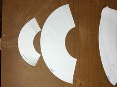 cut out paper shapes sitting on top of a wooden table