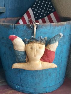 a blue bucket with an image of a woman in the center and american flag on it