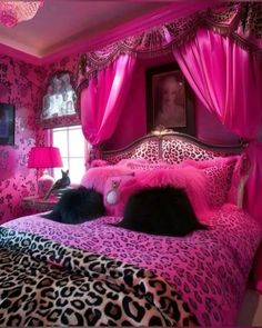 a bedroom with pink and leopard print on the walls, bedding, and curtains