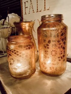 two brown jars sitting on top of a table next to a sign that says fall