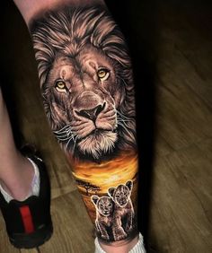 a man's leg with a lion tattoo on it