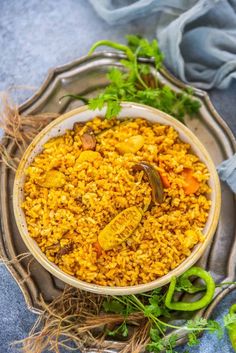 a bowl filled with yellow rice and vegetables