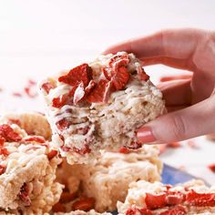 someone is holding up some desserts on a plate with red and white sprinkles