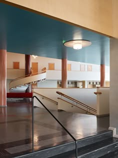 the interior of a building with stairs and railings