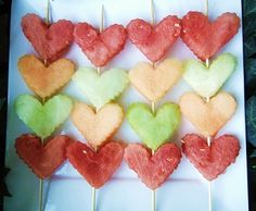 several heart shaped lollipops sitting on top of a white plate