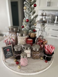 a christmas tree is surrounded by candy and candies on a table in a kitchen