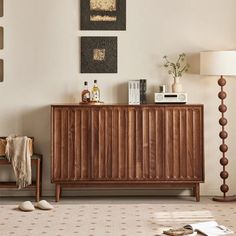 a living room scene with focus on the sideboard and lamps, rugs and pictures