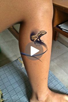 a person with a lizard tattoo on their leg