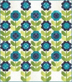 a blue and green quilt with flowers on it