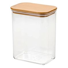 a glass container with a wooden lid on a white background for food storage or organization