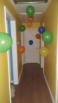 the hallway is decorated with balloons and streamers