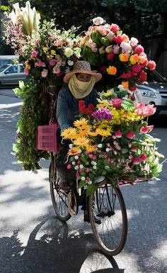 a person riding a bike with flowers on the back