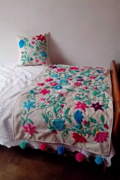 a bed with two pillows on top of it next to a wooden headboard and foot board