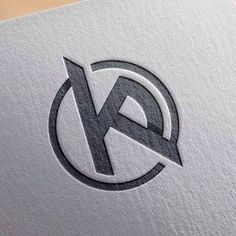 the letter k is inscribed in a circle with an arrow on it's side