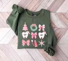 a green sweater with pink bows and christmas decorations