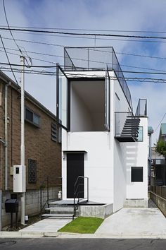 an apartment building with stairs leading up to the second floor