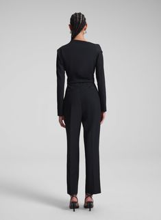 The Skyla Jumpsuit is crafted from our transitional blend suiting fabric in timeless black. This distinctive, one-shoulder silhouette features a wrapped waist and straight legs that hit right at the ankle for a tailored finish. Shop Jumpsuits. Styling Tip: Pair with sleek stilettos and a metallic clutch for a refined evening look. Asymmetric Jumpsuit, Metallic Clutch, Suiting Fabric, Black Jumpsuit, One Shoulder, Straight Leg, Jumpsuit, Sleek, Fabric