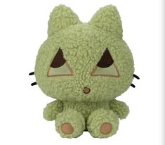 a green stuffed animal with big eyes