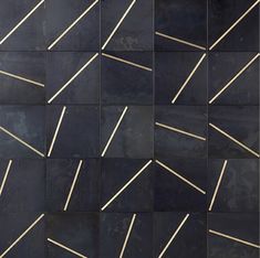 a black wall with gold lines on it