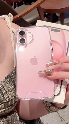 a woman holding an iphone case in her hand and wearing pearls on the ring finger