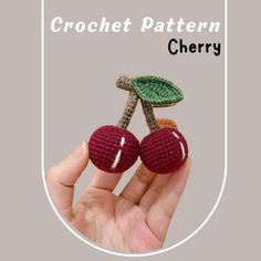 crochet cherry brooch with leaves on top