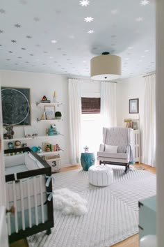 a baby's room with white furniture and stars on the ceiling is shown in this image