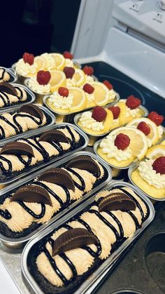 many desserts are lined up in trays on the stove top and ready to be eaten