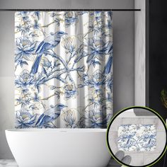 a bath tub sitting next to a shower curtain with blue and white flowers on it