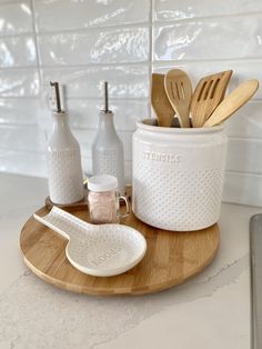 utensils and spoons are sitting on a wooden tray